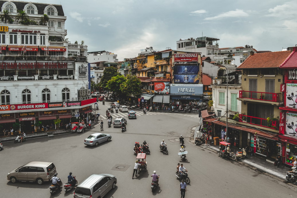 Busy Hanoi Old Quarter with colonial buildings and motorbikes